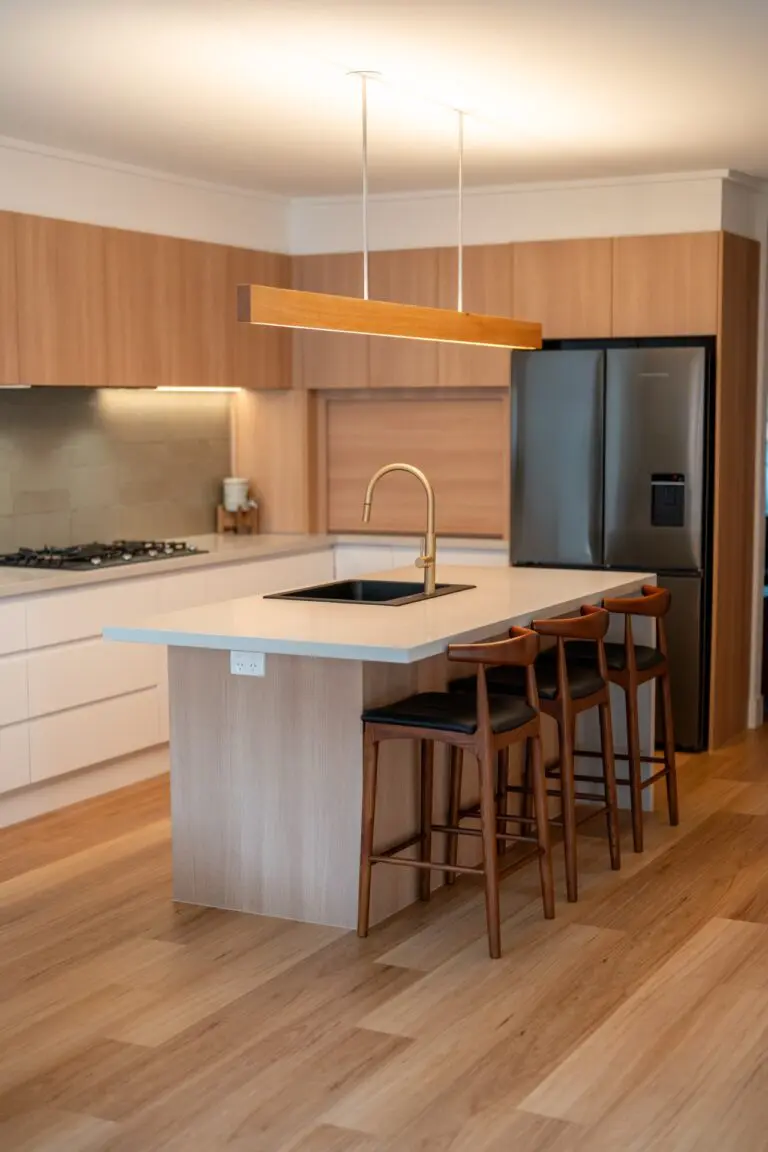 A warm oak island with pendant lighting and timber bar stools