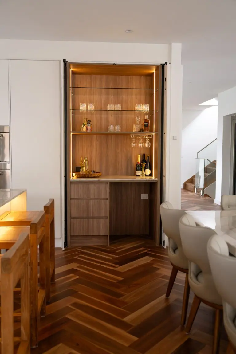 A timber display cabinet lit from within, built into the wall