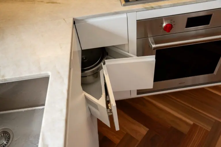A deep pan drawer pulled out beside a built in oven
