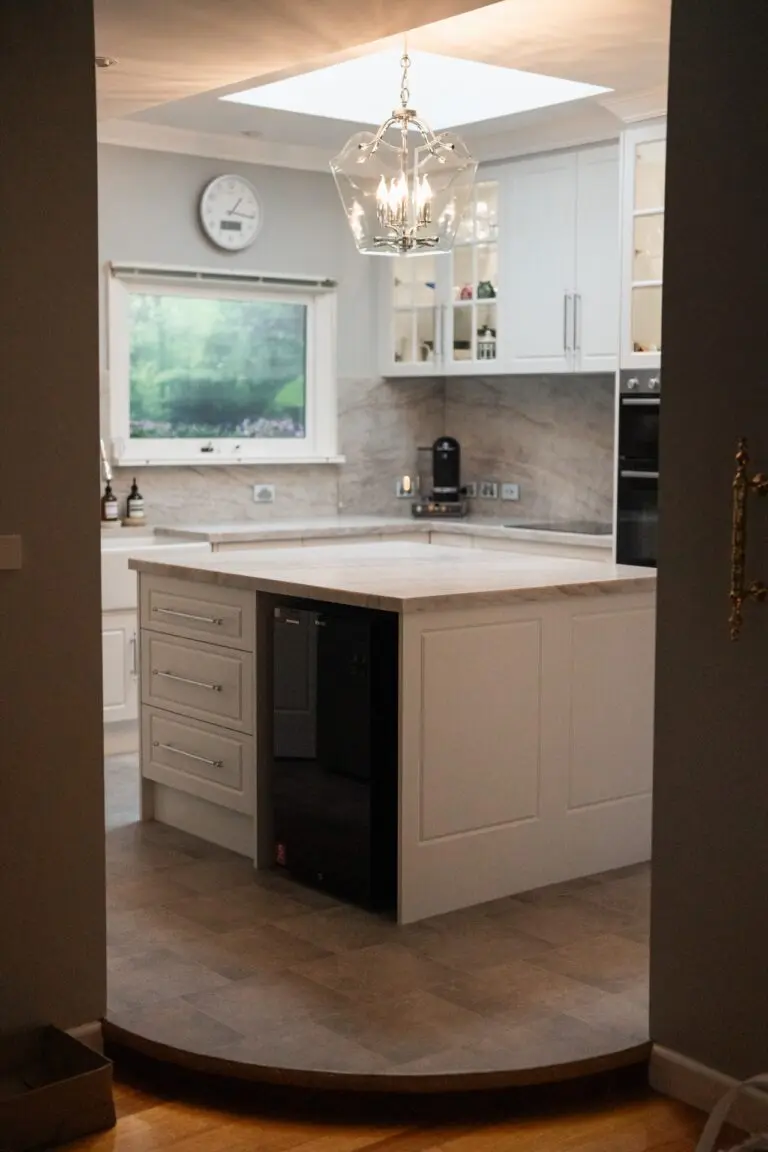 A classic cream island beneath a pendant light