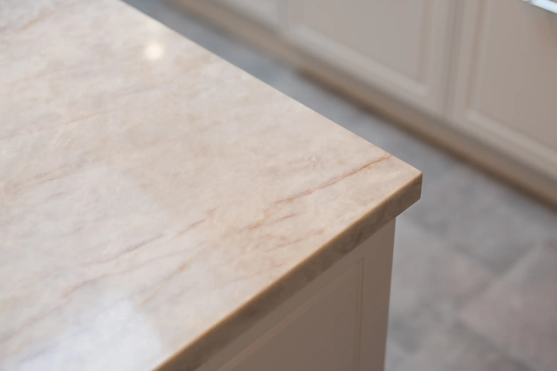 A honed stone benchtop edge in a classic cream kitchen
