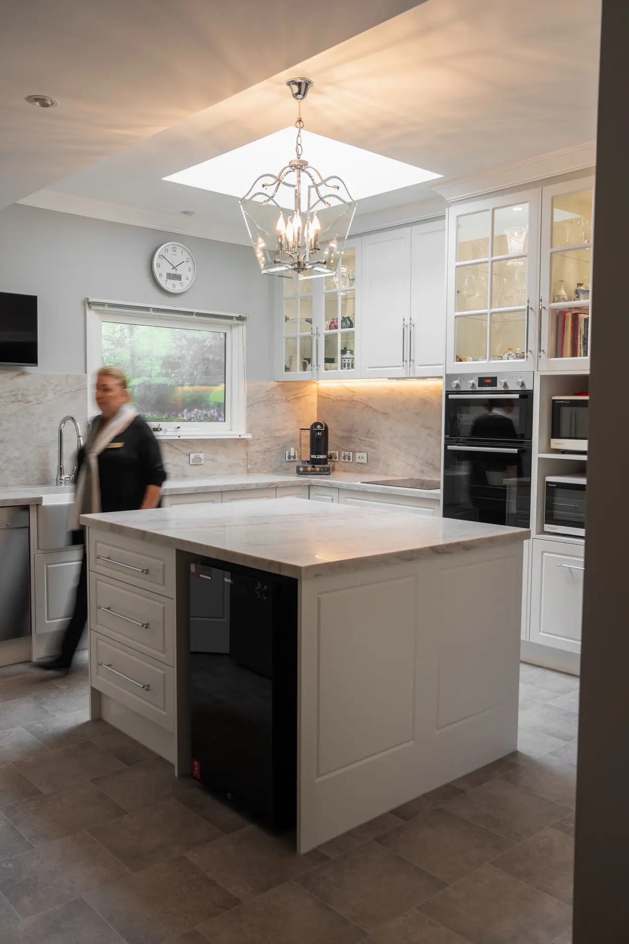A woman working in a classic cream shaker kitchen
