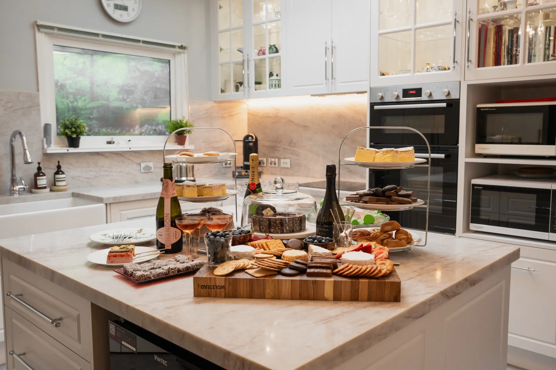 A grazing table laid out across a marble kitchen island